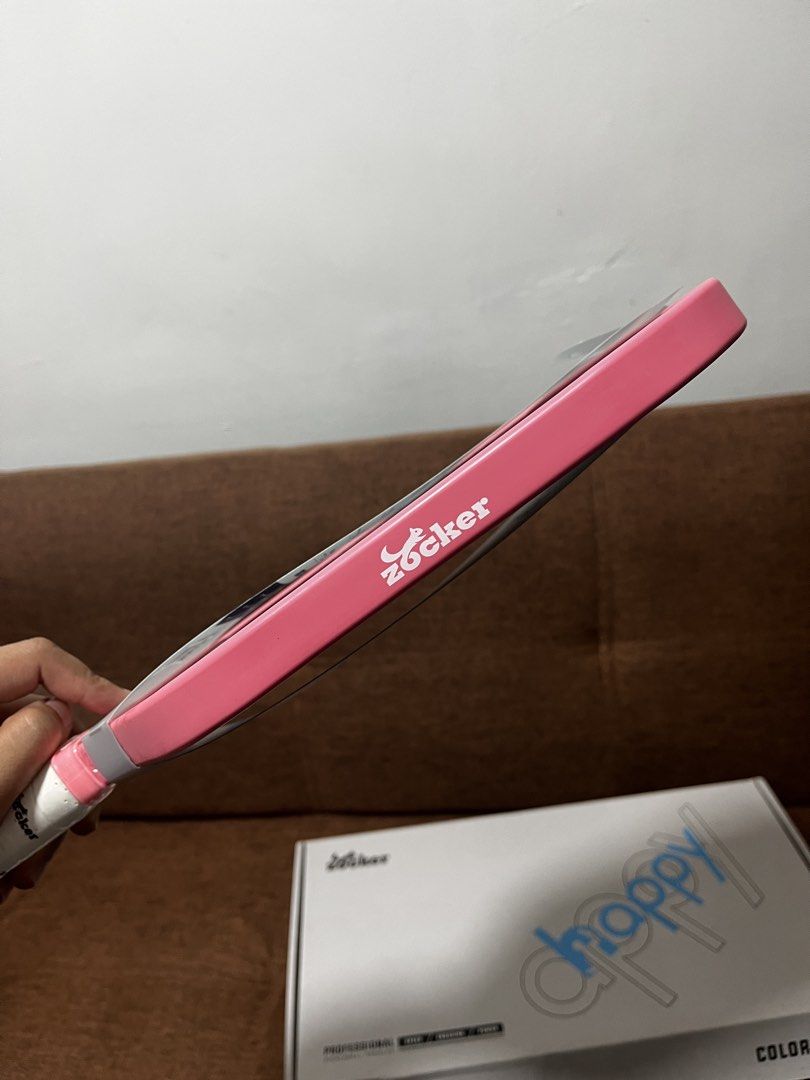 Zocker Happy Hypercontrol 12K Carbon Fiber Pickleball Paddle (Category: Racket and Ball Sports) located in Manila. Submitted by thefootyhub (Listing ID 1467919007, Image 2). Description: NEGOTIABLE Zocker Happy Hypercontrol pickleball paddle. 12K carbon fiber face, power 16mm thickness, PP and EVA honeycomb core. Average weight around 8.1 oz. Pink trim with white perforated grip tape featuring printed brand logos. Includes original box..