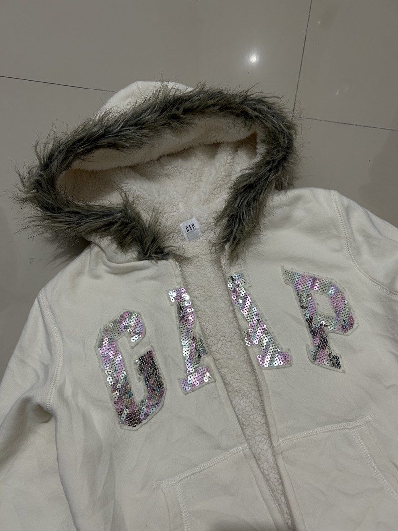 00s archive GAP fur sequin zip hoodie (Category: Coats, Jackets and Outerwear) located in Quezon City. Submitted by commonwealthpickerph (Listing ID 1468073816, Image 3). Description: 00s archive GAP fur sequin zip hoodie - 16 width // length 19.5 - in good condition - Has sign of used - No major issues - minor lints - need wash - Warm and fuzzy sherpa lining with cozy faux fur trim on the hood - Eye-catching large GAP logo in shiny pink and silv