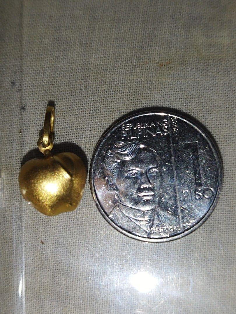 18k Gold Apple Pendant Charm / Pendant (Category: Charms) located in Manila. Submitted by Cie28 (Listing ID 1468172084, Image 2). Description: - 18k Gold apple pendant / charm - Weight: 1.4 grams (verified on digital scale) - Size: Approximately the size of a one-peso coin - Bail: Ready to fit any chain - Style: Versatile piece, great for daily wear or layering - Pawnable .