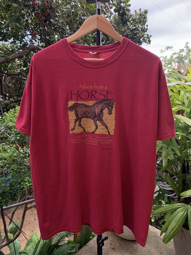 2005 Horse statement tee (Category: Tshirts & Polo Shirts ) located in Cagayan de Oro. Submitted by premium_thrifts (Listing ID 1468174505, Image 2). Description: Burgundy colorway. Good condition. Double stitch on both sleeves and hem Fits XL L28.5" x W23" 22" (shoulder to shoulder) 7.1" (sleeve length) Issue: cut tag, slight fade spots under the graphic, and on some parts Add shipping fee (via JRS or J&T).