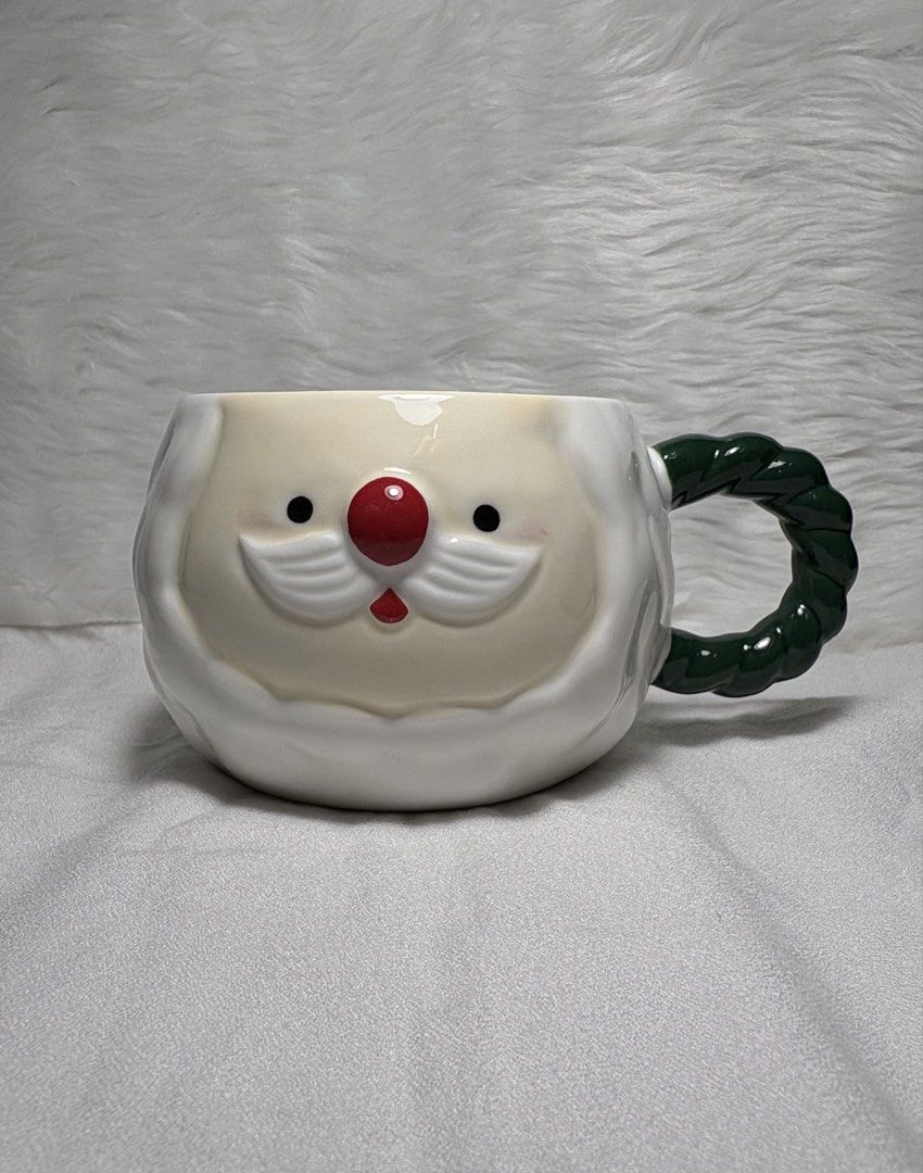 3D Ceramic Santa Claus Christmas Mug (Category: Coffee & Tea Tableware) located in Manila. Submitted by mug.aras (Listing ID 1468222959, Image 1). Description: Get festive with this adorable, high-gloss Santa Claus ceramic mug! Features a molded 3D Santa face with a textured white beard and a unique dark green twisted rope handle. Perfect for holiday hot cocoa or gifting..