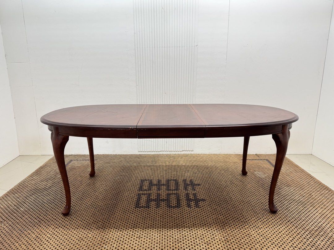 8 seater table (Category: Tables & Sets) located in Quezon City. Submitted by matetdevis13 (Listing ID 1468228800, Image 2). Description: Classic Mahogany-Finish Oval Extendable Dining Table Price: 9,500 L81.5/63.5 x W42 x H30.5 In good condition Code JMD30-M496 The table features a rich reddish-brown finish, elegant curved legs, and a removable center extension leaf that allows it to expand for extra seating..