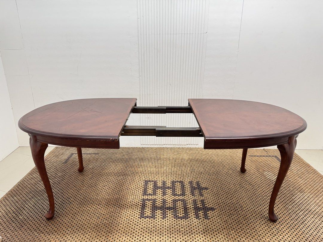 8 seater table (Category: Tables & Sets) located in Quezon City. Submitted by matetdevis13 (Listing ID 1468228800, Image 3). Description: Classic Mahogany-Finish Oval Extendable Dining Table Price: 9,500 L81.5/63.5 x W42 x H30.5 In good condition Code JMD30-M496 The table features a rich reddish-brown finish, elegant curved legs, and a removable center extension leaf that allows it to expand for extra seating..