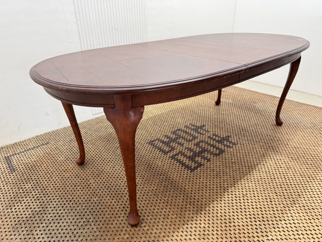 8 seater table (Category: Tables & Sets) located in Quezon City. Submitted by matetdevis13 (Listing ID 1468228800, Image 1). Description: Classic Mahogany-Finish Oval Extendable Dining Table Price: 9,500 L81.5/63.5 x W42 x H30.5 In good condition Code JMD30-M496 The table features a rich reddish-brown finish, elegant curved legs, and a removable center extension leaf that allows it to expand for extra seating..