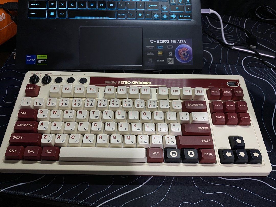 8BitDo Retro Mechanical Keyboard Bluetooth USB 2.4G (Category: Computer Keyboard) located in Makati City. Submitted by warmflower_24b405 (Listing ID 1468232714, Image 3). Description: - Model: 8BitDo Retro Mechanical Keyboard - Colorway: Cream & Burgundy (87 keys with Japanese sub-legends) - Connectivity: Bluetooth, 2.4G wireless, and USB wired - Features: Hot-swappable switches and fully programmable keys - Inclusions: Original box, 2.4G receive