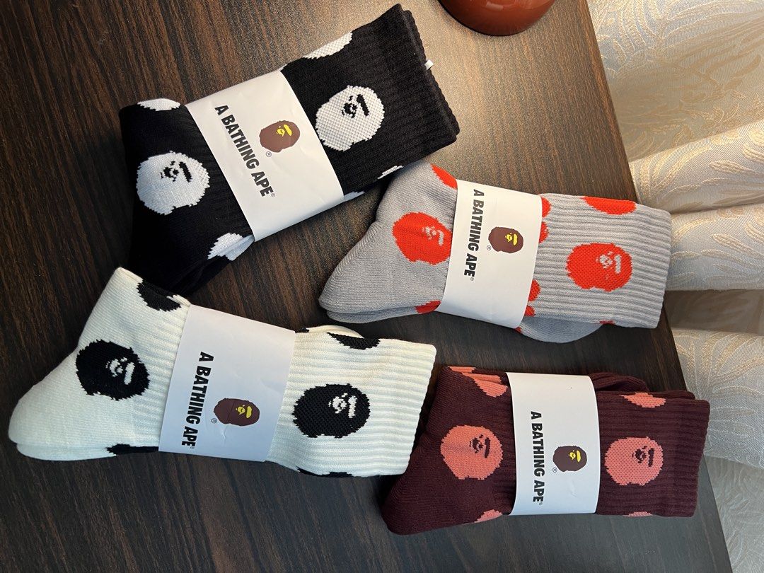 A Bathing Ape Bape Socks (Category: Socks) located in Makati City. Submitted by ciriacoria (Listing ID 1468060038, Image 3). Description: - Bape crew socks - Colors: Grey/red heads, maroon/pink heads, black/white heads & hearts, white/black heads - Condition: Brand new with original paper brand bands - Material: Soft knit cotton fabric with fun all-over graphics - Ideal for streetwear enthusiasts and accessory collectors.