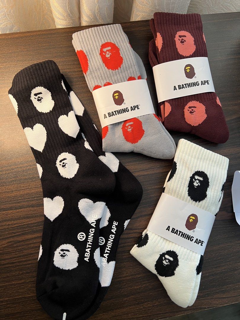 A Bathing Ape Bape Socks (Category: Socks) located in Makati City. Submitted by ciriacoria (Listing ID 1468060038, Image 2). Description: - Bape crew socks - Colors: Grey/red heads, maroon/pink heads, black/white heads & hearts, white/black heads - Condition: Brand new with original paper brand bands - Material: Soft knit cotton fabric with fun all-over graphics - Ideal for streetwear enthusiasts and accessory collectors.