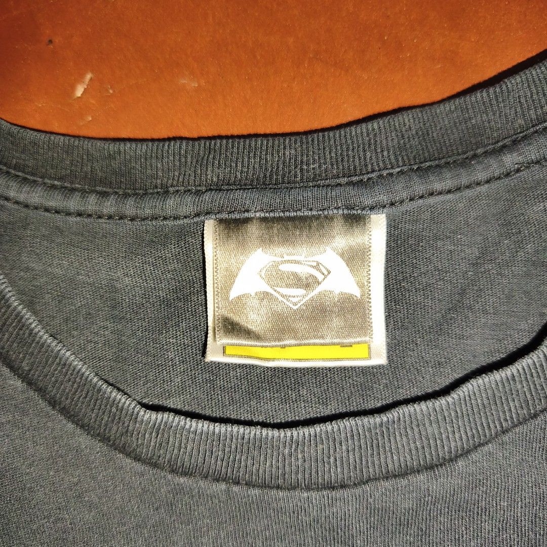 A Bathing Ape Batman v Superman T-Shirt (Category: Tshirts & Polo Shirts ) located in Antipolo. Submitted by alphaomega_fox (Listing ID 1468130073, Image 3). Description: - Brand: Bape x Batman v Superman: Dawn of Justice - Color: Black - Size: Large, 20x26 - Fit: Regular fit with short sleeves and crew neck - Details: Front graphic print, signature Bape sleeve tag, and official DC/Nowhere copyright prints - Condition: Excellent,.