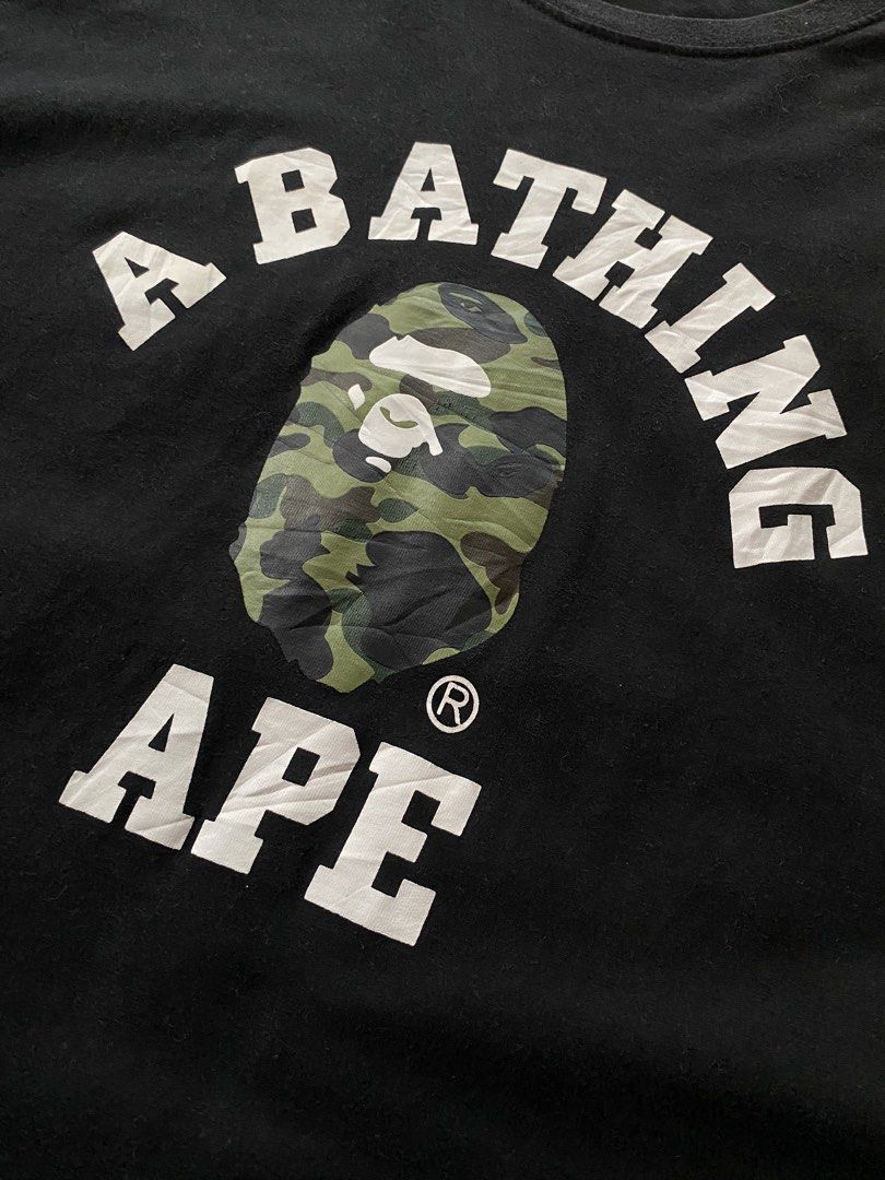 A Bathing Ape Camo Ape Head Tee (Category: Tshirts & Polo Shirts ) located in Manila. Submitted by coollion.19b40f (Listing ID 1468255874, Image 2). Description: - Brand: A Bathing Ape (BAPE) - Color: Black with classic camo ape head graphic and white block lettering - Size: XL - Material: 100% comfortable cotton - Condition: Good, with normal wear around the collar and print - Details: Includes original neck tags and size label - Authentic stree