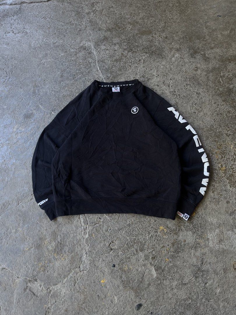 AAPE by A Bathing Ape Black Sweatshirt XL (Category: Coats, Jackets and Outerwear) located in Aguilar. Submitted by brad11thrift (Listing ID 1468186562, Image 1). Description: Black sweatshirt from AAPE by A Bathing Ape. Bold 'AAPE NOW' lettering printed down the left sleeve. Small white and black brand patches on the chest and lower sleeve hem. Inside collar tape repeats the brand name all around. Ribbed cuffs and hem. Size XL on the inner tag..