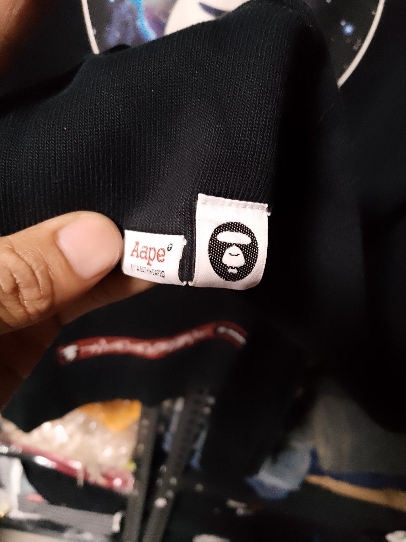 AAPE By A Bathing Ape Universe Space Sweatshirt (Category: Coats, Jackets and Outerwear) located in Manila. Submitted by mjthrifted_second (Listing ID 1468091090, Image 3). Description: - Brand: AAPE by A Bathing Ape - Color: Classic Black -Dimes: 21/28 - Design: Large galaxy graphic with Ape head logo on front, accented with red 'APUNVS' and 'Planet Earth' text - Details: Small branding near the back collar and bold red text near the back hem - 