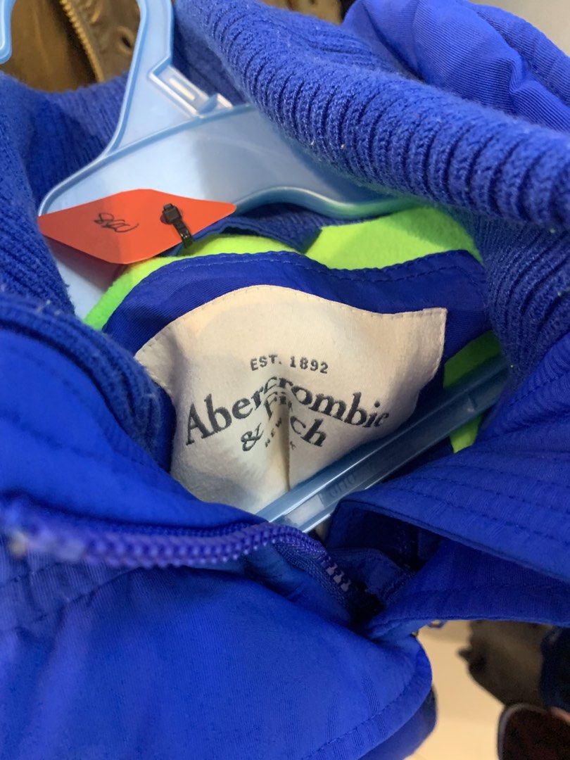 Abercrombie & Fitch Blue Winter Jacket (Category: Coats, Jackets and Outerwear) located in Cuartero. Submitted by johnmichae74239 (Listing ID 1468225280, Image 2). Description: Bright royal blue winter jacket from Abercrombie & Fitch. Neon green interior lining and matching embroidered logo on the chest pocket. Thick ribbed knit collar keeps the wind out. Multiple zippered front pockets for storage. Full zip front with button storm flap. Warm puf