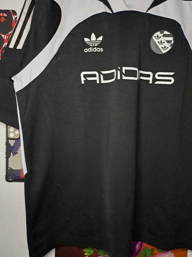 Adidas Adilenium Oversized SS Jersey no Unisex (Category: Activewear) located in Manila. Submitted by yaseen__73 (Listing ID 1468131095, Image 3). Description: Authentic Adidas Originals (Adilenium collection) Design Features: Black and white retro football/soccer jersey styling, V-neck collar, bold centered "ADIDAS" Relaxed, oversized fit with dropped shoulders. Wearing Size : Small on Tag Dimensions : Please Refer to the Photo Color Rate : 10/1