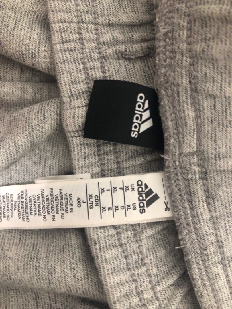 Adidas Essentials FeelComfy French Terry (Category: Joggers) located in Manila. Submitted by kissa.1890 (Listing ID 1468194081, Image 2). Description: - Brand: Adidas - Color: Grey Heather - Size: XL (Interior tag also shows 4XO and XL/TG) - Material: Soft cotton blend - Features: Comfortable elastic waistband - Origin: Made in Vietnam - Condition: Clean inside and out, great for gym or lounging.