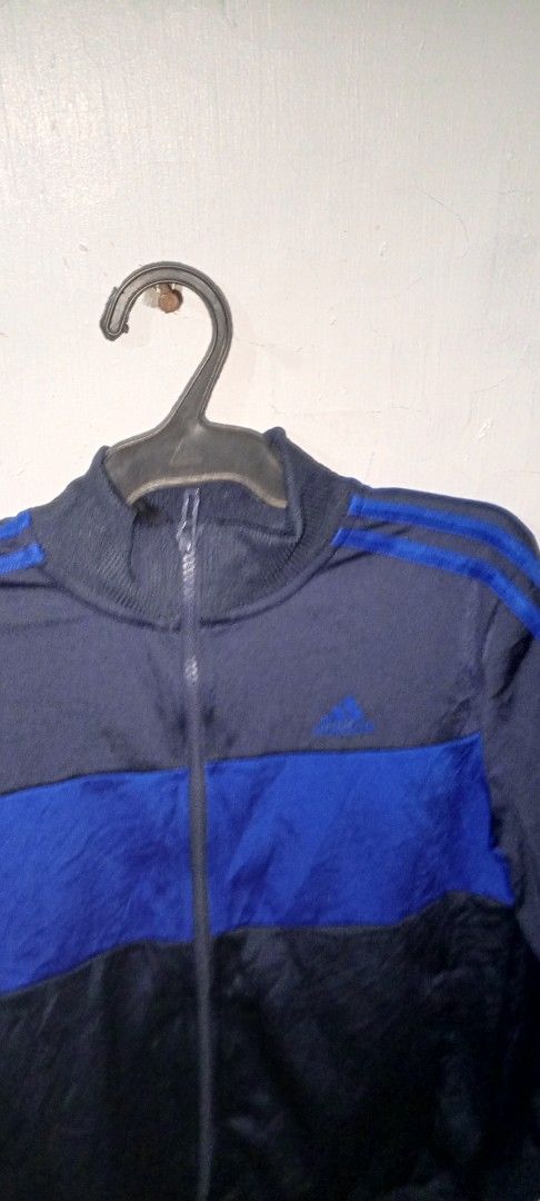 Adidas Navy Blue and Royal Blue Track Jacket (Category: Coats, Jackets and Outerwear) located in Manila. Submitted by ezekislacl02490 (Listing ID 1468282988, Image 3). Description: - Authentic Adidas track jacket - Color: Navy blue and royal blue with distinct horizontal chest block - Design: Classic three stripes on shoulders/sleeves, embroidered logo on right chest - Features: Full zip closure, high collar, ribbed cuffs and hem - Condition: Exc