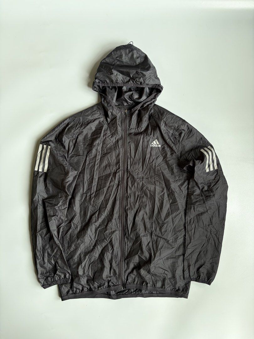 Adidas Own The Run Pack It Jacket (Category: Coats, Jackets and Outerwear) located in Kibawe. Submitted by jeloots (Listing ID 1468123867, Image 1). Description: - Authentic Adidas Own The Run Jacket in black - Durable ripstop fabric construction - Attached adjustable hood for extra weather protection - Full zip front closure - Reflective three stripes on shoulders and sleeves for low-light visibility - Convenient packable design - Size: Asian L 