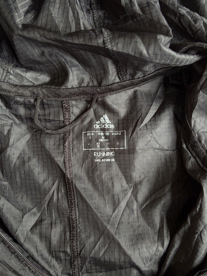 Adidas Own The Run Pack It Jacket (Category: Coats, Jackets and Outerwear) located in Kibawe. Submitted by jeloots (Listing ID 1468123867, Image 3). Description: - Authentic Adidas Own The Run Jacket in black - Durable ripstop fabric construction - Attached adjustable hood for extra weather protection - Full zip front closure - Reflective three stripes on shoulders and sleeves for low-light visibility - Convenient packable design - Size: Asian L 