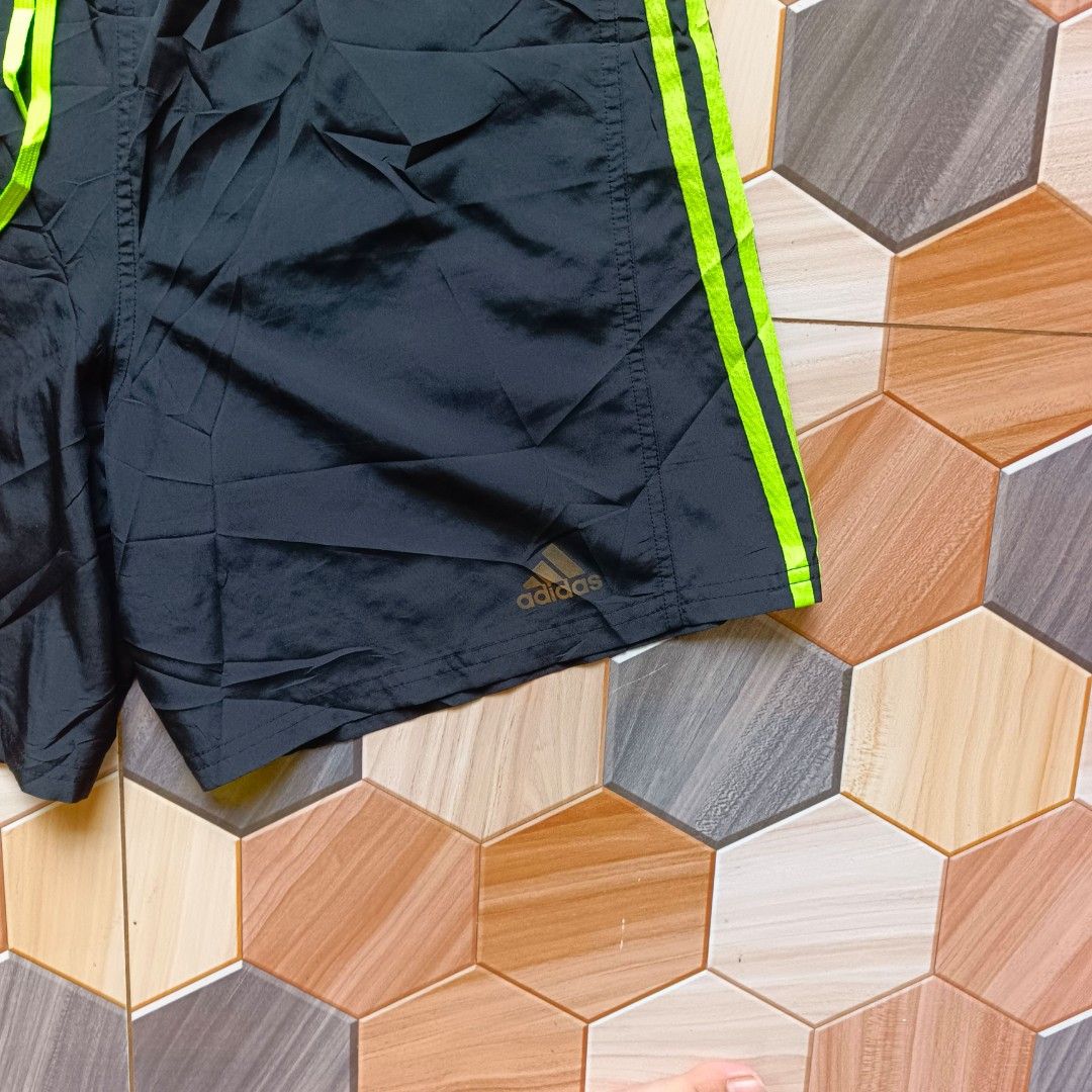 Adidas Response Running Shorts Black Green (Category: Shorts) located in Manila. Submitted by caps08 (Listing ID 1468257513, Image 3). Description: Adidas Response running shorts in black with neon green stripes and matching drawstring. Bright green mesh inner lining for breathability. Back zipper pocket for keys or small items. Lightweight fabric, great for workouts or daily runs..