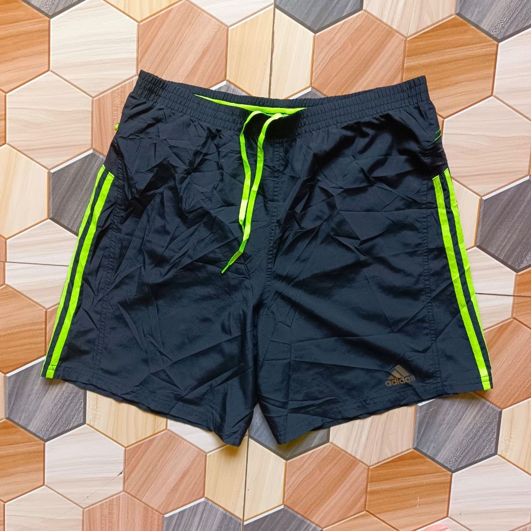 Adidas Response Running Shorts Black Green (Category: Shorts) located in Manila. Submitted by caps08 (Listing ID 1468257513, Image 2). Description: Adidas Response running shorts in black with neon green stripes and matching drawstring. Bright green mesh inner lining for breathability. Back zipper pocket for keys or small items. Lightweight fabric, great for workouts or daily runs..
