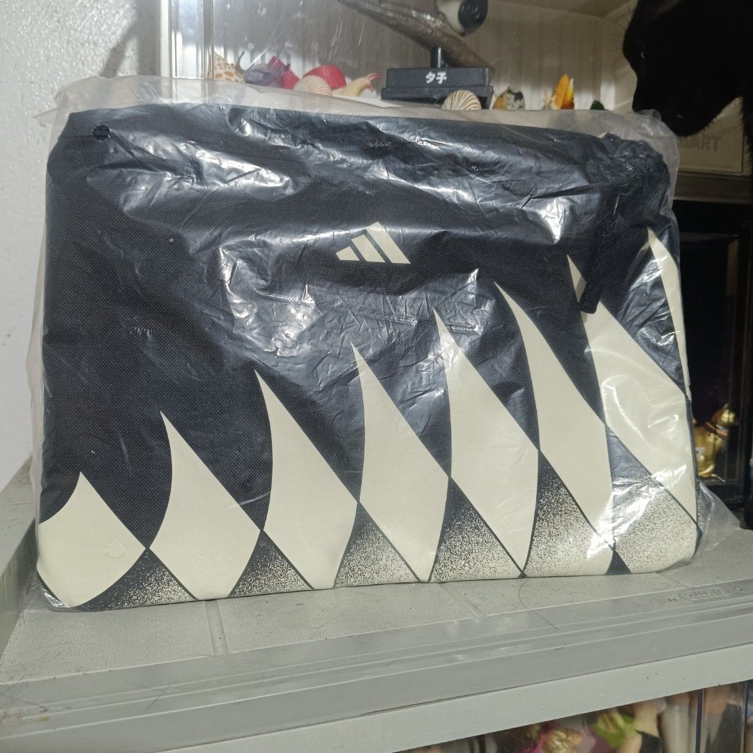 Adidas Tiro Sacoche bag (Category: Sling Bags) located in Quezon City. Submitted by hexxxa (Listing ID 1468185730, Image 1). Description: - Brand: Adidas Tiro Sacoche - Condition: Brand new, sealed in original plastic packaging with tags attached - Design: Black and white colorway with geometric spike pattern and classic Adidas logo - Type: Compact zipper pouch shoulder bag - Usage: Ideal for carrying everyday essentials Novaliches bayan area pic