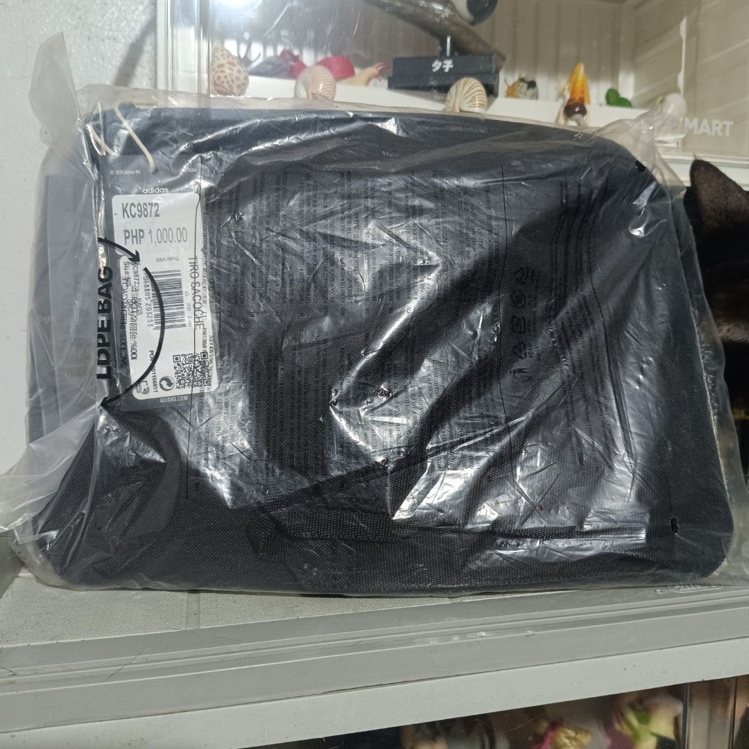 Adidas Tiro Sacoche bag (Category: Sling Bags) located in Quezon City. Submitted by hexxxa (Listing ID 1468185730, Image 2). Description: - Brand: Adidas Tiro Sacoche - Condition: Brand new, sealed in original plastic packaging with tags attached - Design: Black and white colorway with geometric spike pattern and classic Adidas logo - Type: Compact zipper pouch shoulder bag - Usage: Ideal for carrying everyday essentials Novaliches bayan area pic