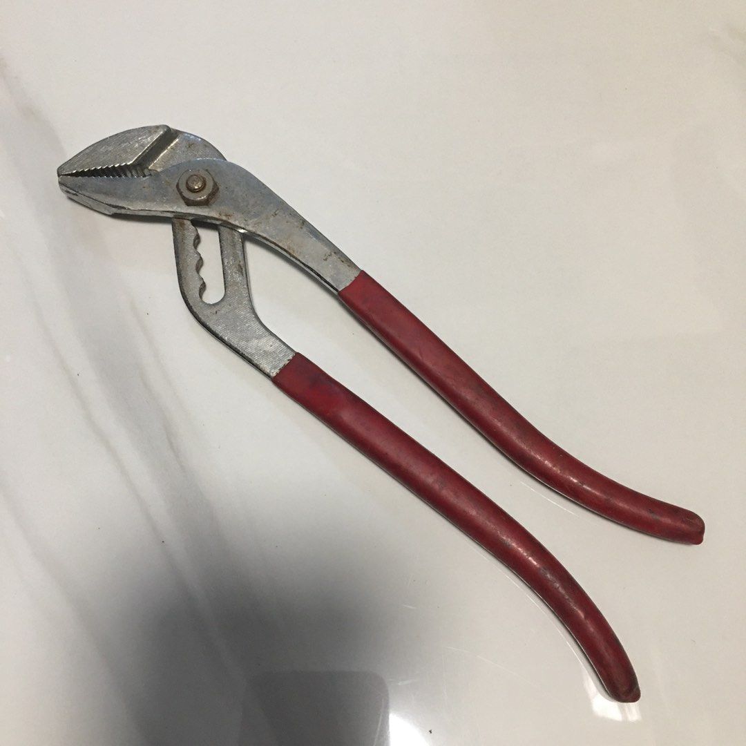 Adjustable slip joint pliers with red handles (Category: Construction Tools & Equipment) located in Pasay City. Submitted by gilbertso62551 (Listing ID 1468156417, Image 1). Description: - Tool: 8-inch adjustable slip joint pliers - Grip: Textured red rubber for a secure hold - Design: Multi-position groove joint for adjustable jaw openings - Condition: Steel body with minor surface rust around the pivot nut and teeth; cleaned and ready for work 