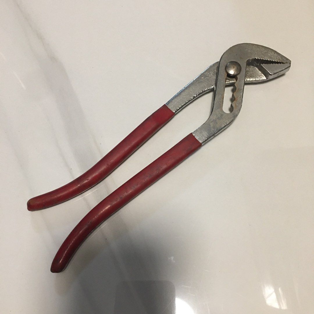 Adjustable slip joint pliers with red handles (Category: Construction Tools & Equipment) located in Pasay City. Submitted by gilbertso62551 (Listing ID 1468156417, Image 2). Description: - Tool: 8-inch adjustable slip joint pliers - Grip: Textured red rubber for a secure hold - Design: Multi-position groove joint for adjustable jaw openings - Condition: Steel body with minor surface rust around the pivot nut and teeth; cleaned and ready for work 