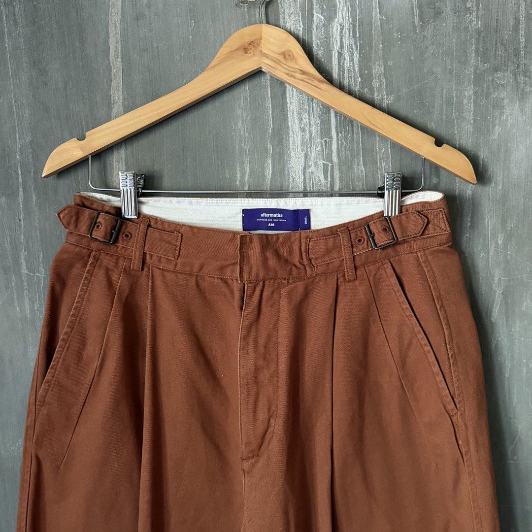 aftermaths Heritage Pleated Gurkha Pants (Category: Trousers) located in Puerto Princesa. Submitted by terdsthrift (Listing ID 1468256453, Image 3). Description: aftermaths Heritage Pleated Gurkha Pants Waist: 30 Length: 38 Thigh: 13.5 Hem: 8 In Excellent Condition / No Issue Color Rate: 10/10 - Brand: Aftermaths - Size: Small - Material: 100% cotton - Color: Deep rust-brown - Fit: Relaxed tapered leg - Features: Side adjuster buckles at waistban