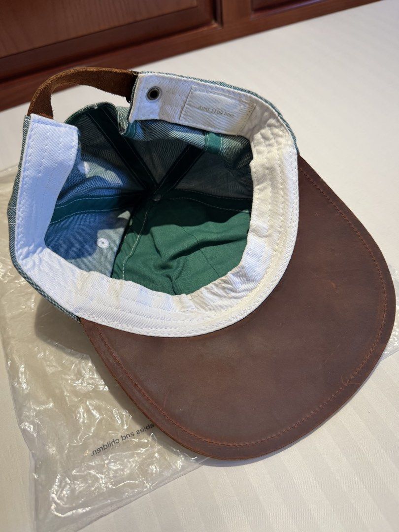 Aime Leon Dore Unisphere Oxford Cap (Category: Caps & Hats) located in Makati City. Submitted by keiiiiichan (Listing ID 1468076838, Image 2). Description: - Brand: Aimé Leon Dore - Model: Unisphere Oxford Cap (FW20) - Color: Green with contrasting brown leather brim - Details: Embroidered gold logo patch on front - Closure: Adjustable leather strap at the back - Inclusion: Original branded plastic bag .