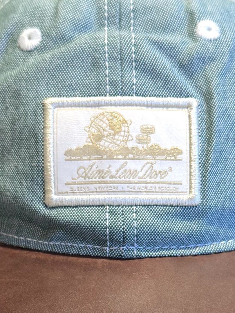 Aime Leon Dore Unisphere Oxford Cap (Category: Caps & Hats) located in Makati City. Submitted by keiiiiichan (Listing ID 1468076838, Image 3). Description: - Brand: Aimé Leon Dore - Model: Unisphere Oxford Cap (FW20) - Color: Green with contrasting brown leather brim - Details: Embroidered gold logo patch on front - Closure: Adjustable leather strap at the back - Inclusion: Original branded plastic bag .
