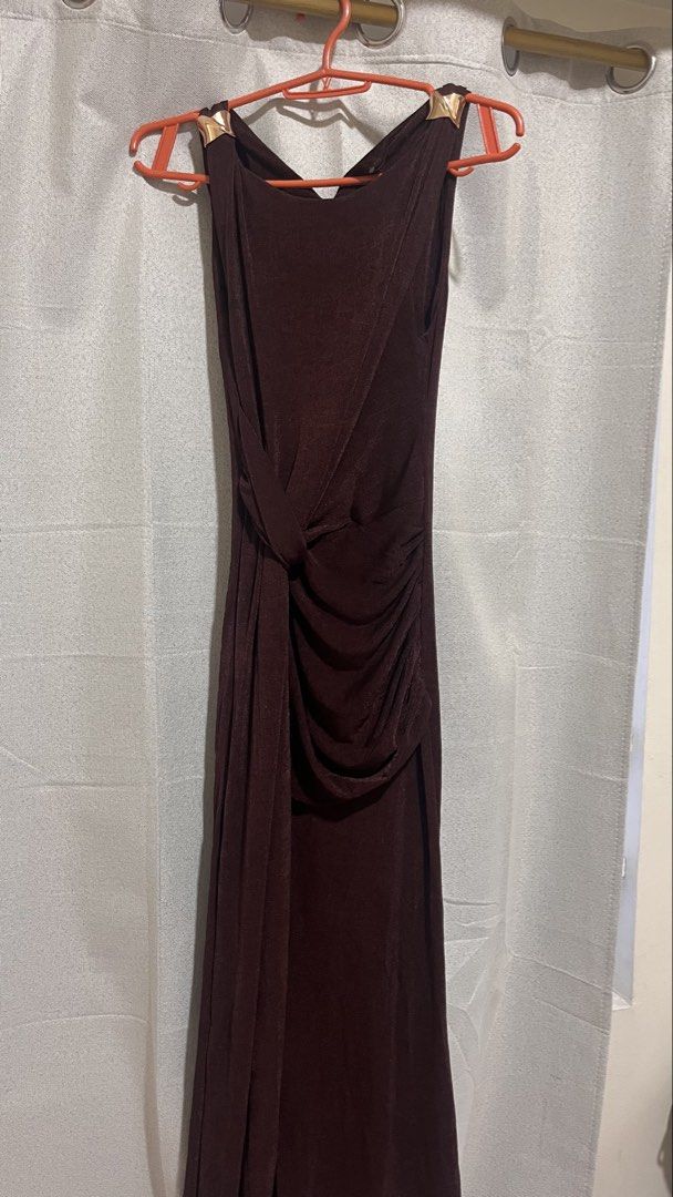 A-Line Sleeveless Dress (Category: Dresses) located in Santa Rita. Submitted by cnmgaux (Listing ID 1468142797, Image 1). Description: - Brand/Style: Lumalex sleeveless maxi dress - Color: Coffee Brown - Key Features: Unique metallic gold shoulder hardware and dramatic side drape tied at the waist - Material: Stretchy and comfortable fabric - Occasion: Ideal for formal events, parties, or weddings Used once Meet-up: Greenfields, Mandaluyong or SM