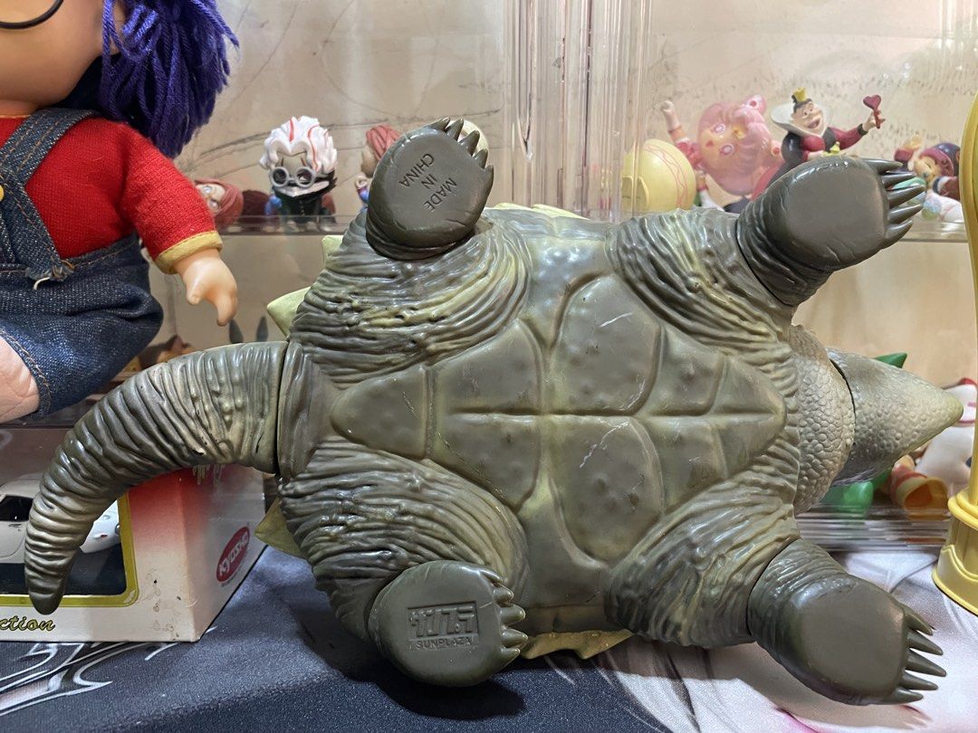 Alligator Snapping Turtle Toy Action Figure (Category: Figurines & Statues) located in Agdangan. Submitted by kuradekawaii_06 (Listing ID 1468095993, Image 3). Description: - Detailed alligator snapping turtle action figure - Features a greenish-brown scaly body and a sharp, spiky shell - Wide open mouth showing a realistic reddish tongue - Textured claws and posable tail and limbs - Stamped Sunplaza on the bottom of one foot - Perfect collectibl