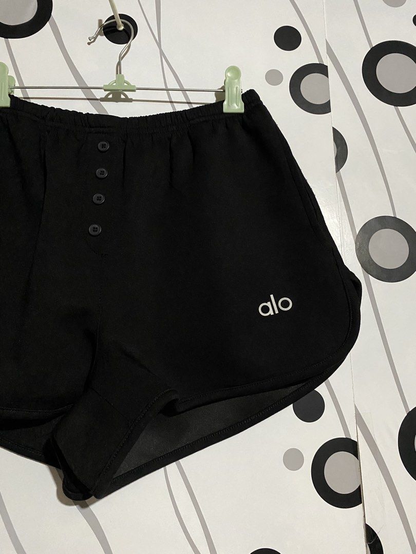 ALO Shorts (Category: Shorts) located in Cebu City. Submitted by patspickph (Listing ID 1468173605, Image 2). Description: This is a black athletic or lounge shorts with a button-placket detail and a white "alo" logo on the leg. Free size waistline Excellent Condition.
