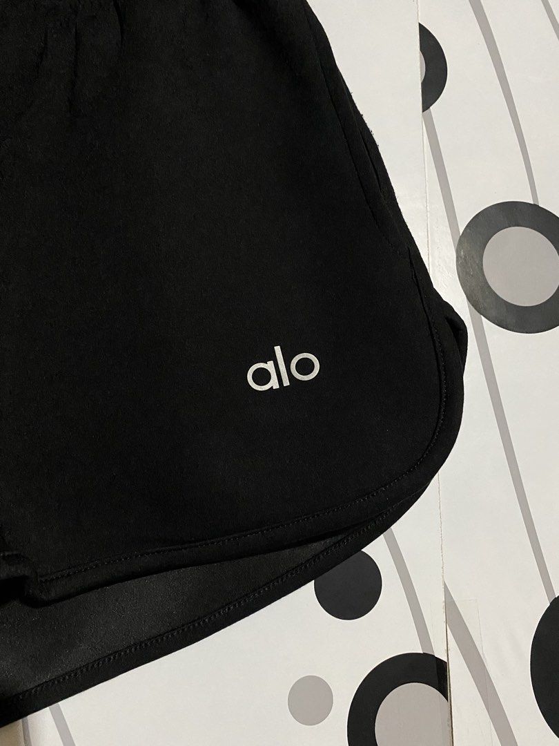 ALO Shorts (Category: Shorts) located in Cebu City. Submitted by patspickph (Listing ID 1468173605, Image 3). Description: This is a black athletic or lounge shorts with a button-placket detail and a white "alo" logo on the leg. Free size waistline Excellent Condition.