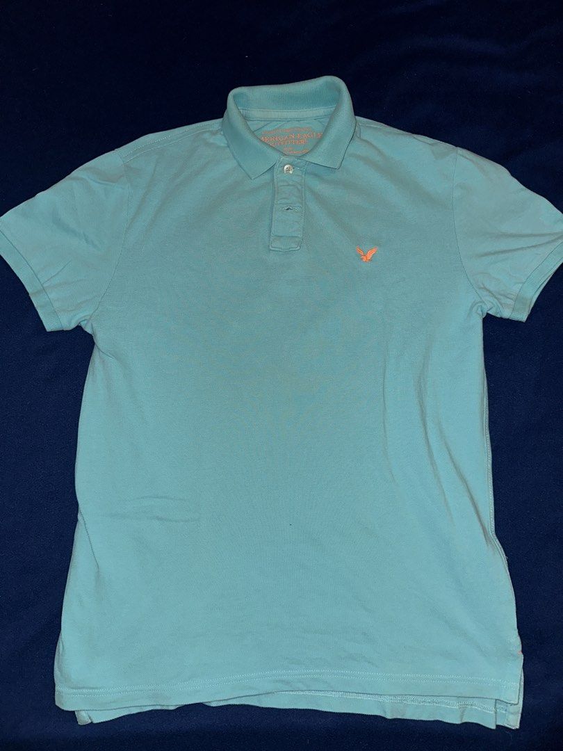 American Eagle Polo shirt (Category: Tshirts & Polo Shirts ) located in Quezon City. Submitted by mancave_stuff (Listing ID 1468168789, Image 1). Description: Authentic American Eagle Men’s Polo Shirt (Turquoise / Teal) American Eagle short-sleeve polo shirt in a vibrant turquoise / light teal color. Features a contrasting neon orange embroidered eagle logo on the chest. Very comfortable, lightweight pique cotton material. • Brand: American Eagle