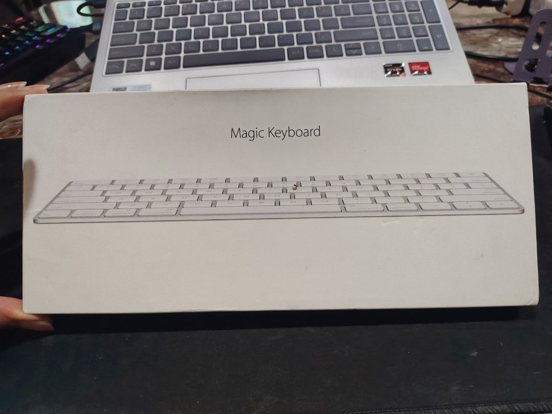 Apple Magic Keyboard with Touch ID (Category: Computer Keyboard) located in Mandaluyong City. Submitted by Love.Boutique (Listing ID 1468077910, Image 1). Description: - Authentic Apple Magic Keyboard with original box included - Clean white keys and sleek silver aluminum frame - Condition note: Down arrow keycap is loose or missing the top piece, but the switch underneath works perfectly - Ideal for use as a spare keyboard or an easy repair proj