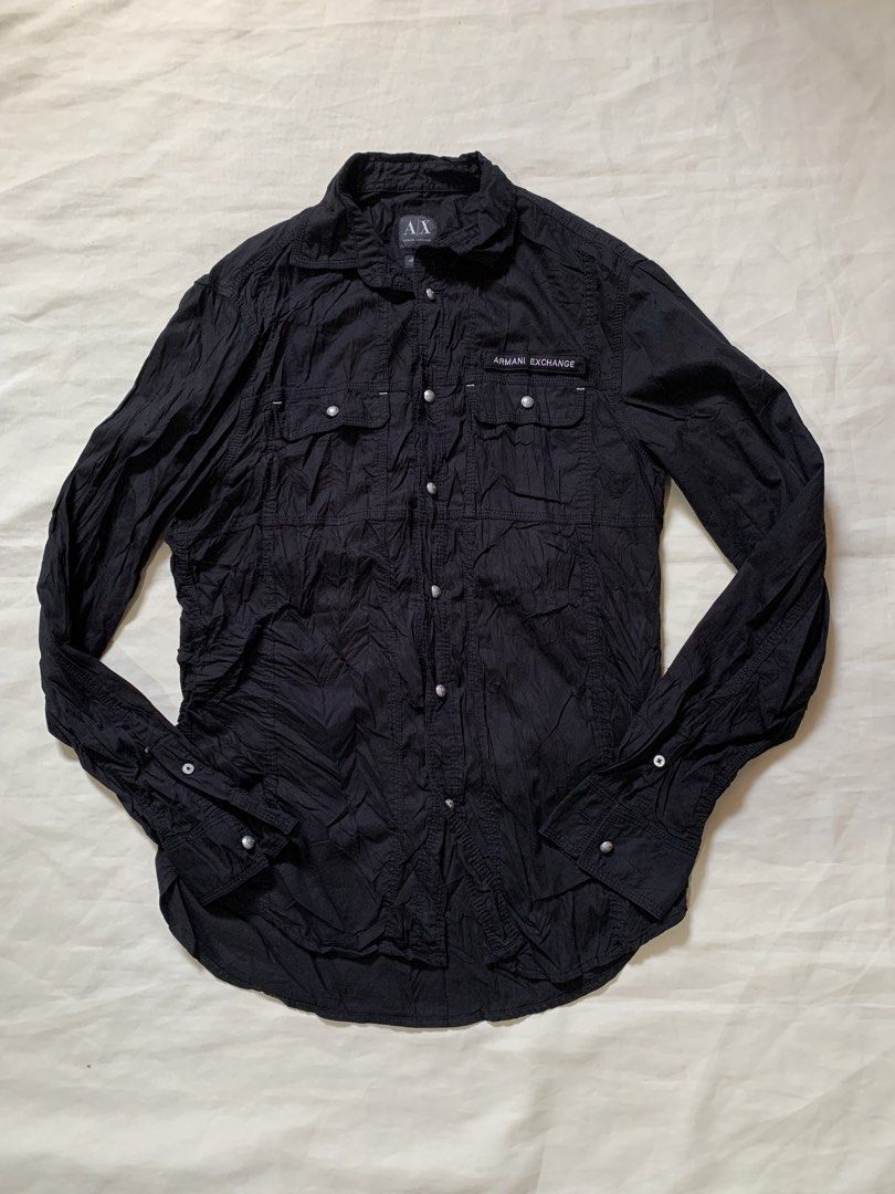 Armani Exchange Black Long Sleeve Button-Down Shirt (Category: Longsleeves) located in Davao. Submitted by cheineebau09680 (Listing ID 1468203072, Image 1). Description: - Brand: Armani Exchange - Color: Classic Black - Style: Long sleeve button-down shirt with textured fabric finish - Features: Dual front chest pockets with button closures - Detachable Armani Exchange logo patch on velcro - Premium branded silver-tone metal hardware on buttons a