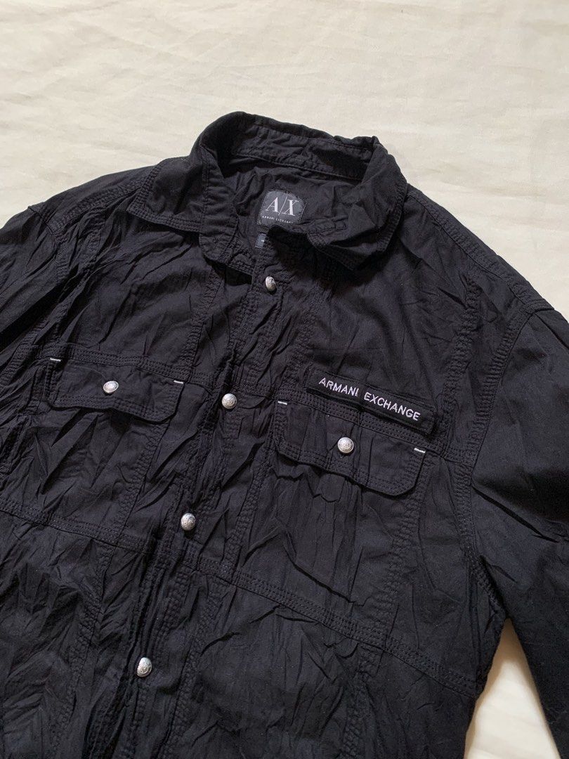 Armani Exchange Black Long Sleeve Button-Down Shirt (Category: Longsleeves) located in Davao. Submitted by cheineebau09680 (Listing ID 1468203072, Image 2). Description: - Brand: Armani Exchange - Color: Classic Black - Style: Long sleeve button-down shirt with textured fabric finish - Features: Dual front chest pockets with button closures - Detachable Armani Exchange logo patch on velcro - Premium branded silver-tone metal hardware on buttons a