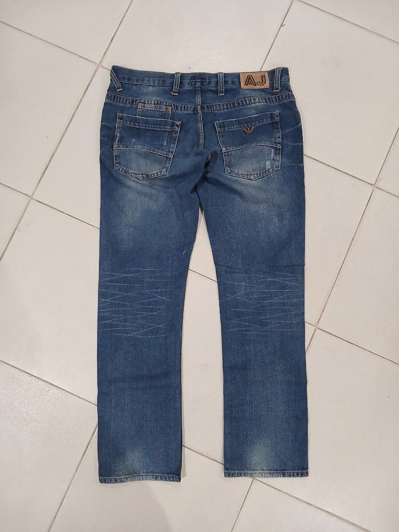 Armani Jeans Denim Pants (Category: Chinos) located in Daraga. Submitted by thethriftcity2024 (Listing ID 1468105586, Image 2). Description: - Brand: Armani Jeans (GA Operations S.p.A. Italy) - Color/Wash: Classic blue with clean wash and subtle thigh whiskering - Fit/Style: Straight leg, button fly, branded button closure - Material: 100% premium cotton - Details: Signature metal AJ badge on back pocket, contrast stitching, and inner yellow trim