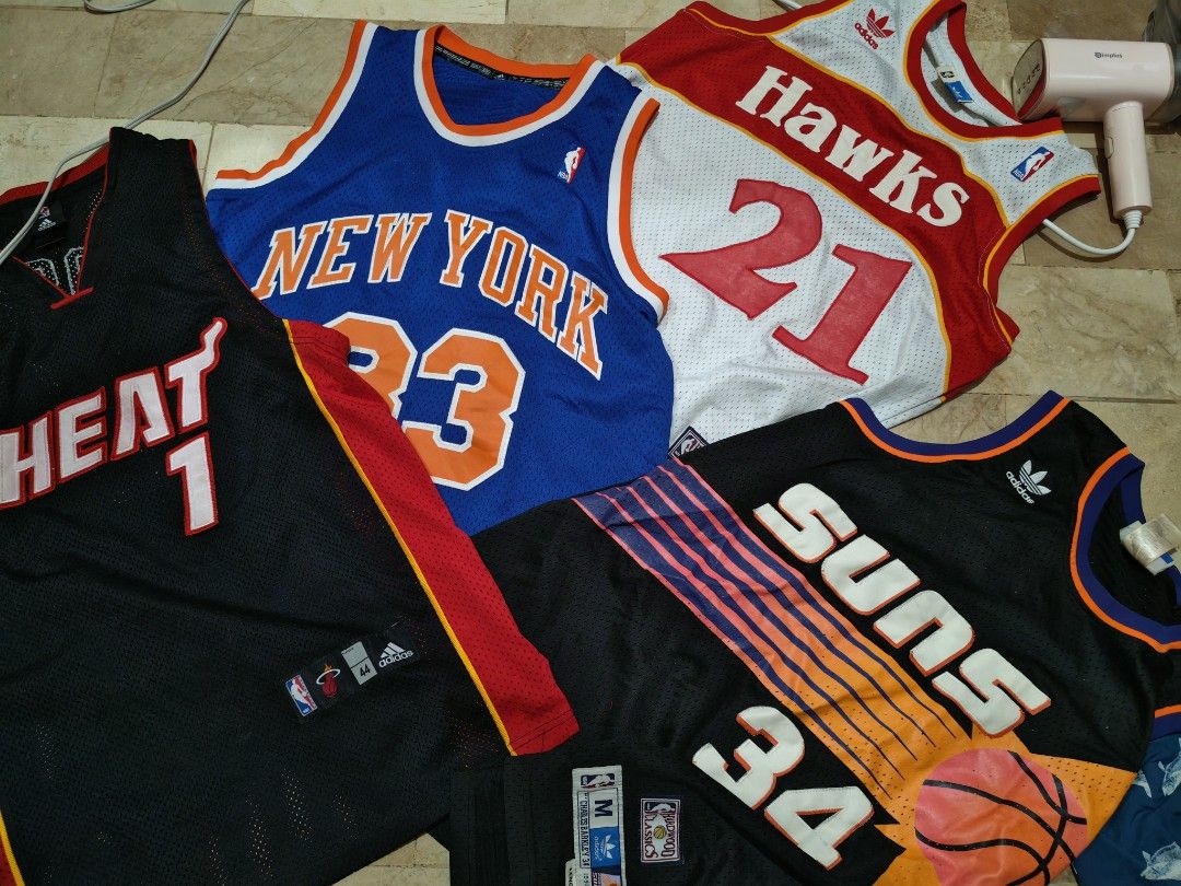 Assorted NBA Basketball Jerseys Adidas & Mitchell & Ness (Category: Activewear) located in Tagum. Submitted by Villanuevarex2795 (Listing ID 1468105434, Image 2). Description: - Bundle of 4 classic NBA basketball jerseys - Miami Heat #1 (Black) - New York Knicks #23 (Blue) - Atlanta Hawks #21 (White & Red) - Phoenix Suns Charles Barkley #34 Hardwood Classics (Black) - Features high-quality stitched numbers and lettering - Sizes vary across the se
