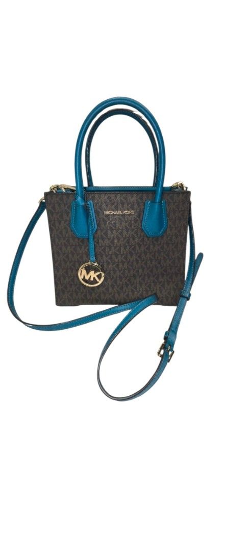 AUTH MICHAEL KORS MED CONVERTIBLE TOTE BAG (Category: Shoulder Bags) located in Baguio. Submitted by zia_zab (Listing ID 1468068678, Image 1). Description: Michael Kors Mercer Small Convertible Tote features a brown monogram pattern with teal accents. It has a top handle and a detachable shoulder strap. The interior has a zippered pocket and a small slip pocket. The bag has a gold-tone MK logo charm. The interior lining is teal. Slightly used, so