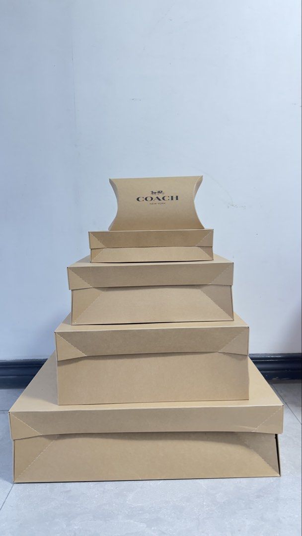 Authentic Coach Gift Boxes Various Sizes (Category: Accessory Holder, Box & Organizers) located in Quezon City. Submitted by dendionlineshop (Listing ID 1468155589, Image 2). Description: Big box - 250 Large - 200 Medium - 150 Small - 100 - Authentic Coach gift boxes in assorted sizes and shapes - Includes both flat pillow boxes and standard lidded boxes - Classic brown cardboard finish with iconic Coach New York logo - Perfect for gifting, organ