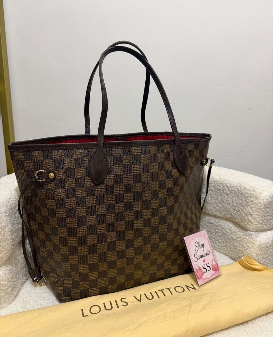 Authentic Louis Vuitton Neverfull MM Damier Ebene (Category: Luxury Bags & Wallets) located in Pasig City. Submitted by sheyfabph (Listing ID 1468082587, Image 2). Description: Authentic Louis Vuitton Neverfull MM in classic Damier Ebene canvas Rank ab Excellent structure: No cracks on the leather or canvas with dustbag 46k.