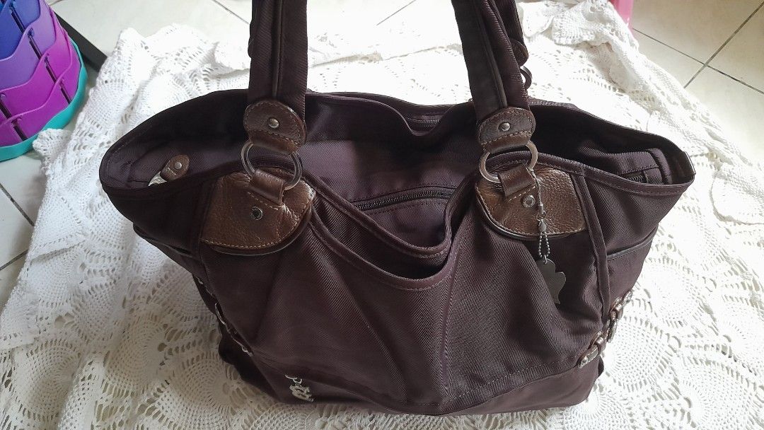 Authentic TOUS Brown Nylon & Leather Tote Bag (Category: Shoulder Bags) located in Manila. Submitted by jocelyn527 (Listing ID 1468110529, Image 3). Description: 💯 Authentic TOUS Brown Nylon & Leather Tote Bag ✨ PERFECT FOR EVERY OCCASION: 👩‍💼 Work & Office — Fits your laptop, documents, wallet, and essentials — looks professional and polished 📚 School & College — Lightweight yet durable — spacious enough for notebooks, books, and daily items
