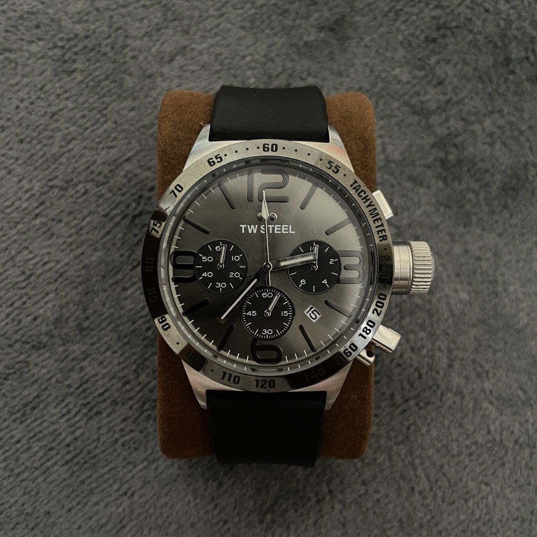 Authentic TW Steel Chronograph (working) (Category: Men's Watches) located in Manila. Submitted by rdfinds (Listing ID 1468217651, Image 1). Description: Brand / Model: TW Steel Canteen Chronograph Movement: Quartz Chronograph Dial Color: Sunray Gunmetal/Grey with contrasting black subdials and hands Indices: Large oversized 12, 3, 6, 9 Arabic numerals with stick hour markers Bezel: Stainless steel tachymeter outer bezel Crown: Signature oversize