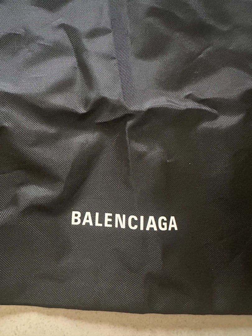 Balenciaga Black Drawstring Backpack Bag (Category: Backpacks) located in Caloocan City. Submitted by prelovebyoreo (Listing ID 1468281872, Image 2). Description: Black nylon drawstring bag with white Balenciaga logo printed near the bottom. Double cord straps on both sides. Measures approximately 19 inches in height and 16 inches in width based on tape measurements. Lightweight material..