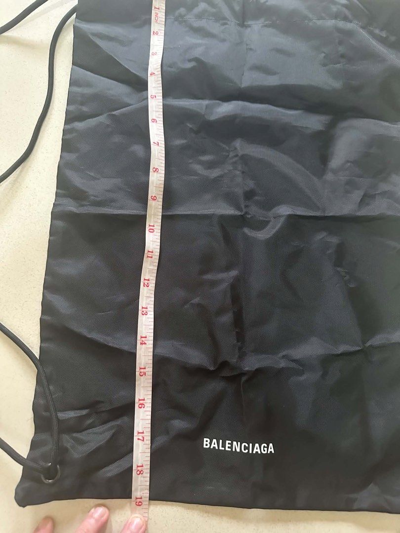 Balenciaga Black Drawstring Backpack Bag (Category: Backpacks) located in Caloocan City. Submitted by prelovebyoreo (Listing ID 1468281872, Image 3). Description: Black nylon drawstring bag with white Balenciaga logo printed near the bottom. Double cord straps on both sides. Measures approximately 19 inches in height and 16 inches in width based on tape measurements. Lightweight material..