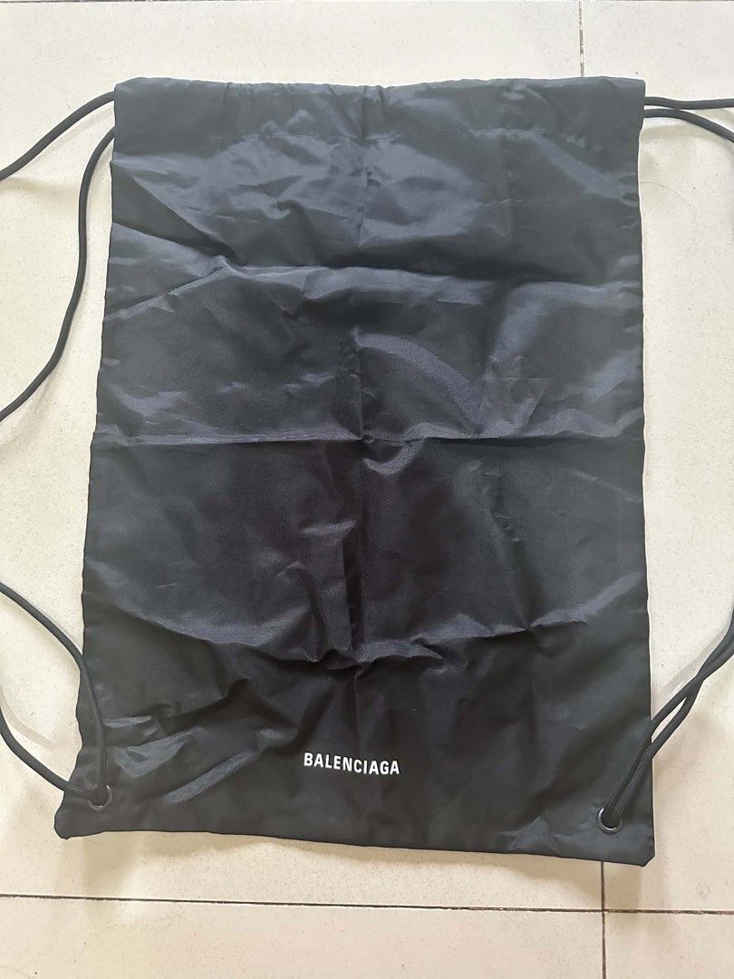 Balenciaga Black Drawstring Backpack Bag (Category: Backpacks) located in Caloocan City. Submitted by prelovebyoreo (Listing ID 1468281872, Image 1). Description: Black nylon drawstring bag with white Balenciaga logo printed near the bottom. Double cord straps on both sides. Measures approximately 19 inches in height and 16 inches in width based on tape measurements. Lightweight material..