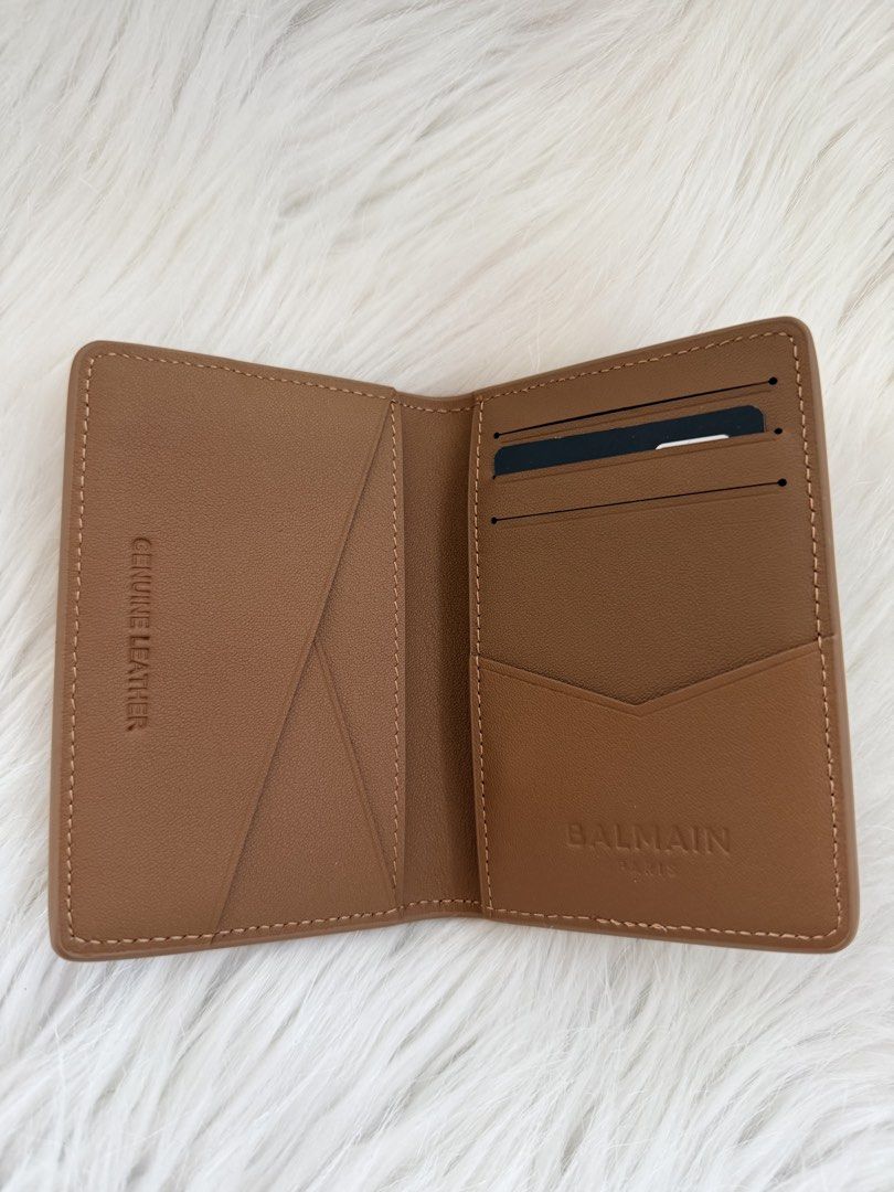 Balmain Paris Bifold Wallet (Category: Luxury Bags & Wallets) located in Cainta. Submitted by mskath__ (Listing ID 1468094167, Image 2). Description: - Authentic Balmain Paris card holder - Premium tan brown pebble grain leather - Iconic gold-tone Balmain "B" logo hardware on the front flap - Multiple interior and exterior card slots and slip pockets - Genuine leather interior stamping with debossed Balmain Paris branding - Condition: Brand new /