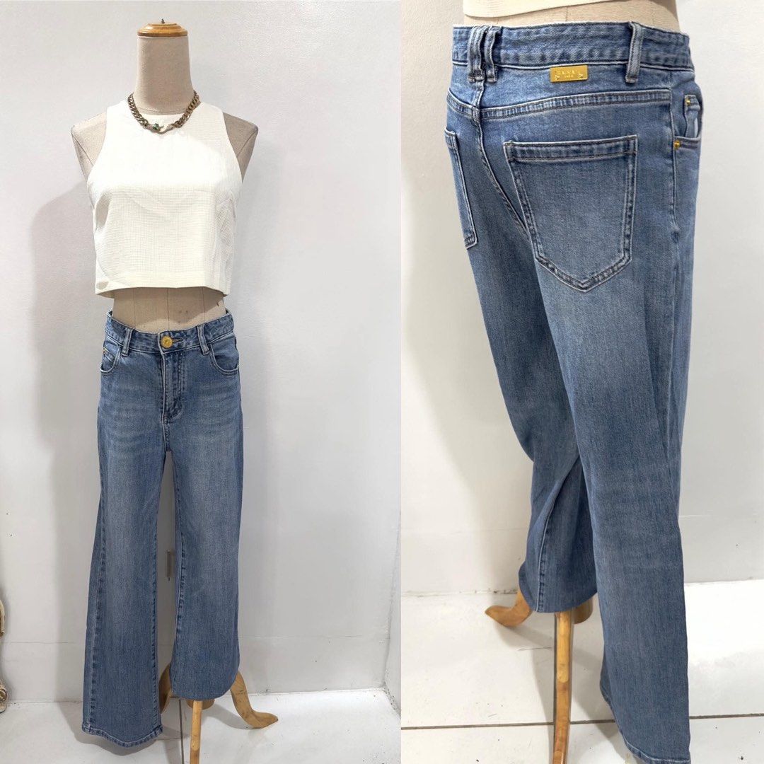 Balmain Paris Denim Jeans (Category: Jeans) located in Bacolod City. Submitted by bhabissagal-05763 (Listing ID 1468141694, Image 2). Description: - Brand: Balmain Paris - Color/Wash: Medium blue, clean solid wash - Fit: Straight wide leg - Details: Gold metal button closure with embossed branding and matching gold rear logo plaque - Pockets: Classic back pockets - Condition/Style: Versatile everyday luxury denim.